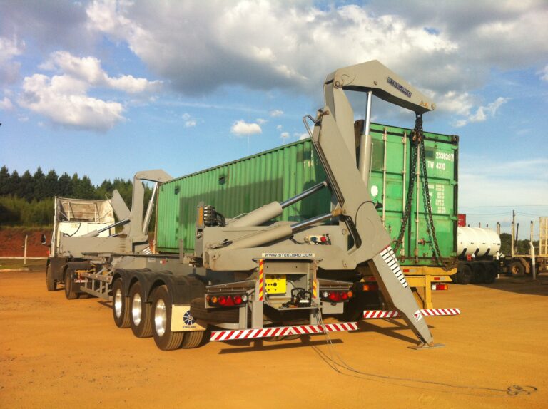 Sidelifter trailer on a truck transferring containers